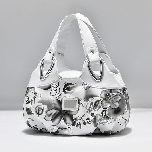 Elegante PU Leder Damenhandtasche mit farbigem Blumenprint. Große Schultertasche für Alltag, Büro und Reisen – modisch & praktisch.

