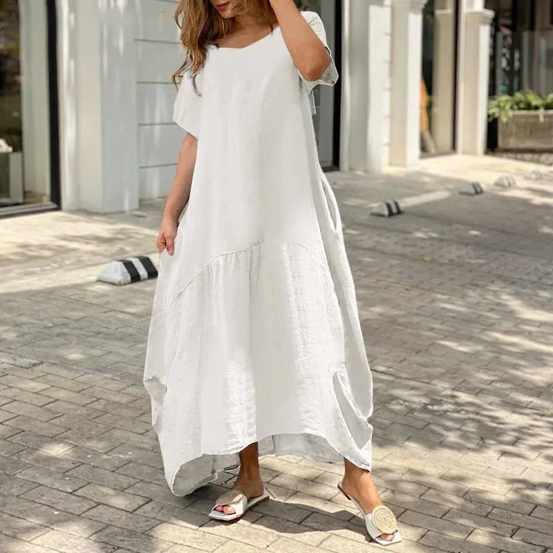 2025 Frühling/Sommer Trend: Langes, lockeres weißes Damenkleid aus Baumwolle. Kurze Ärmel und elegantes, bequemes Design für einen lässigen Stil.

